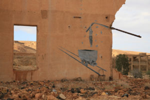 A mural on a destroyed house wall with a window