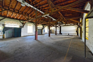 Interior view of a hall with wooden roof.