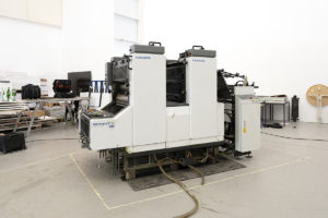 Photo shows a large printing machine.